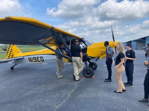 Students look at an aircraft during the fly-in event. 